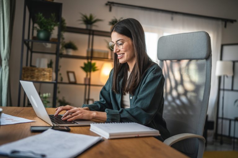 adult,woman,work,on,laptop,and,use,notebook,from,home